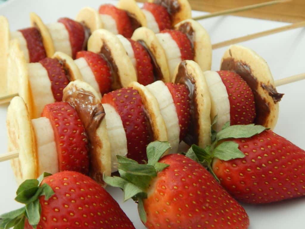 fruit kebabs on white cutting board