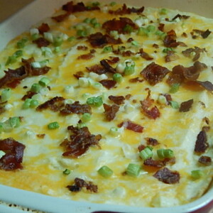 Loaded baked potato casserole in red baking dish