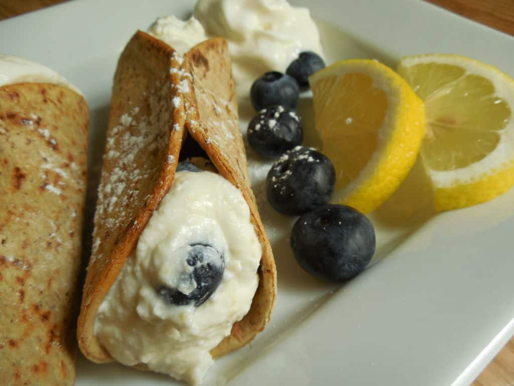 weight watcher friendly cannoli on white plate with lemon and blueberries