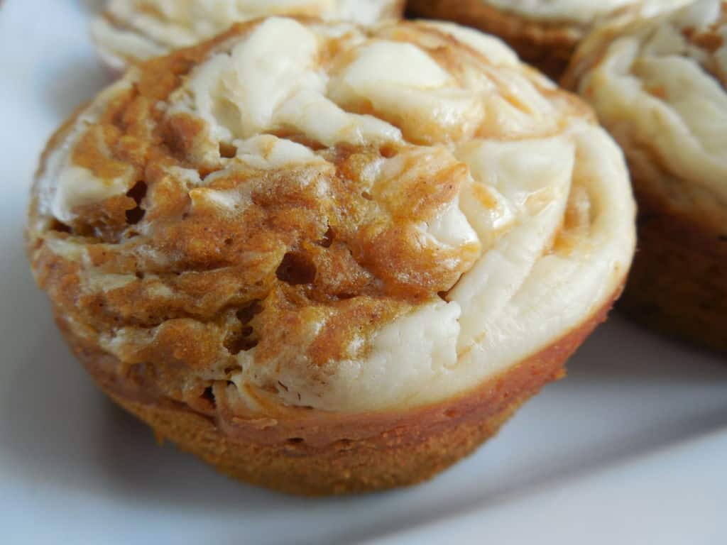 Pumpkin cream cheese muffin on white plate