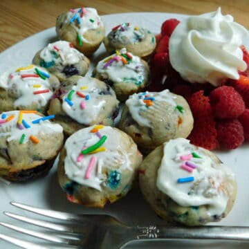 Mini blueberry pancake muffins with fork and white plate