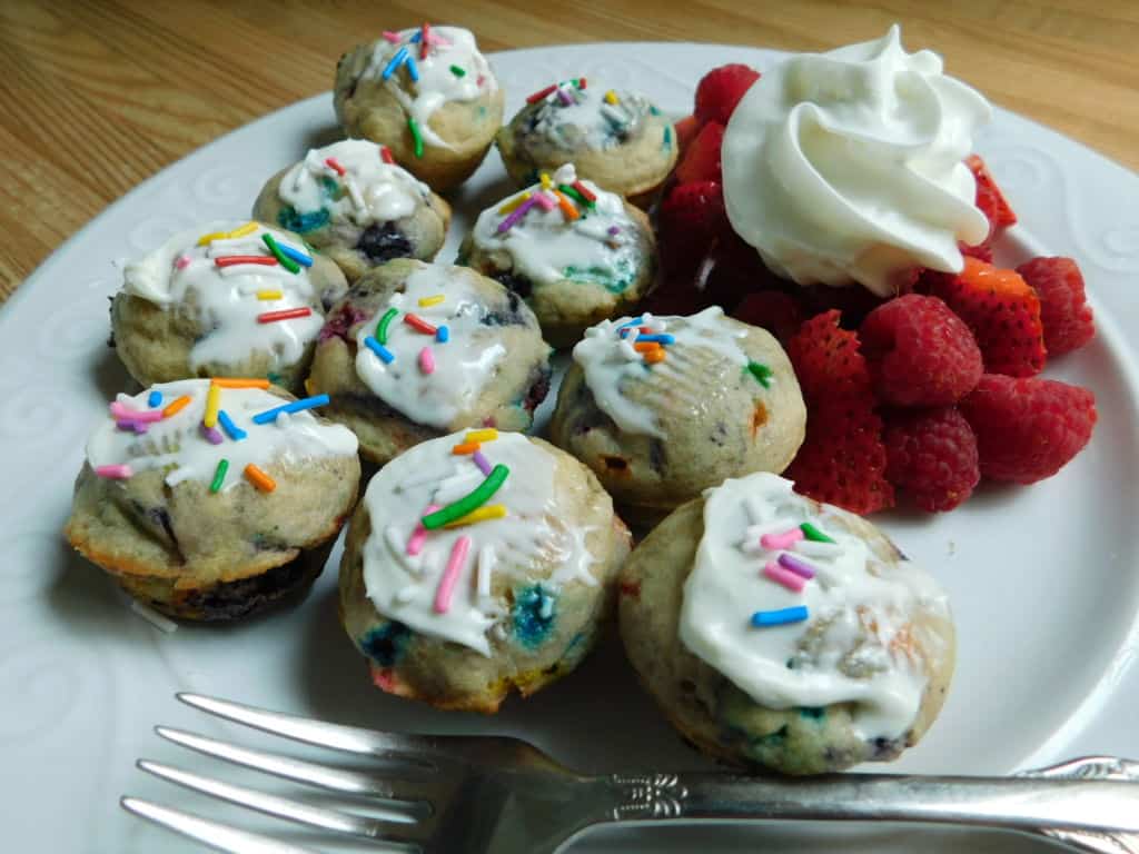 Mini blueberry pancake muffins with fork and white plate