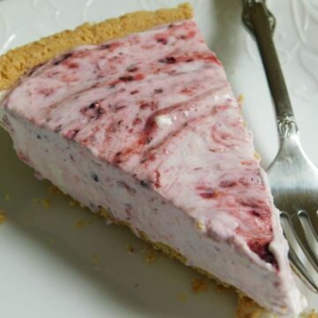 weight watchers friendly berry cheesecake with fork on white plate