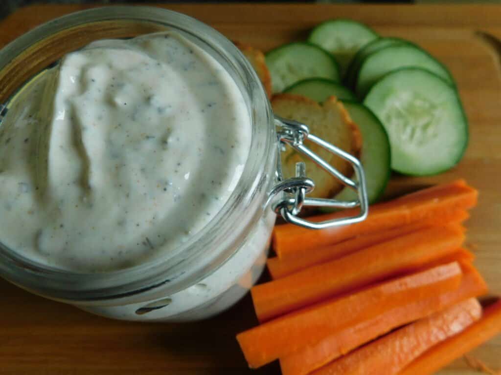 Ranch dressing dip with carrots and cucumbers. 