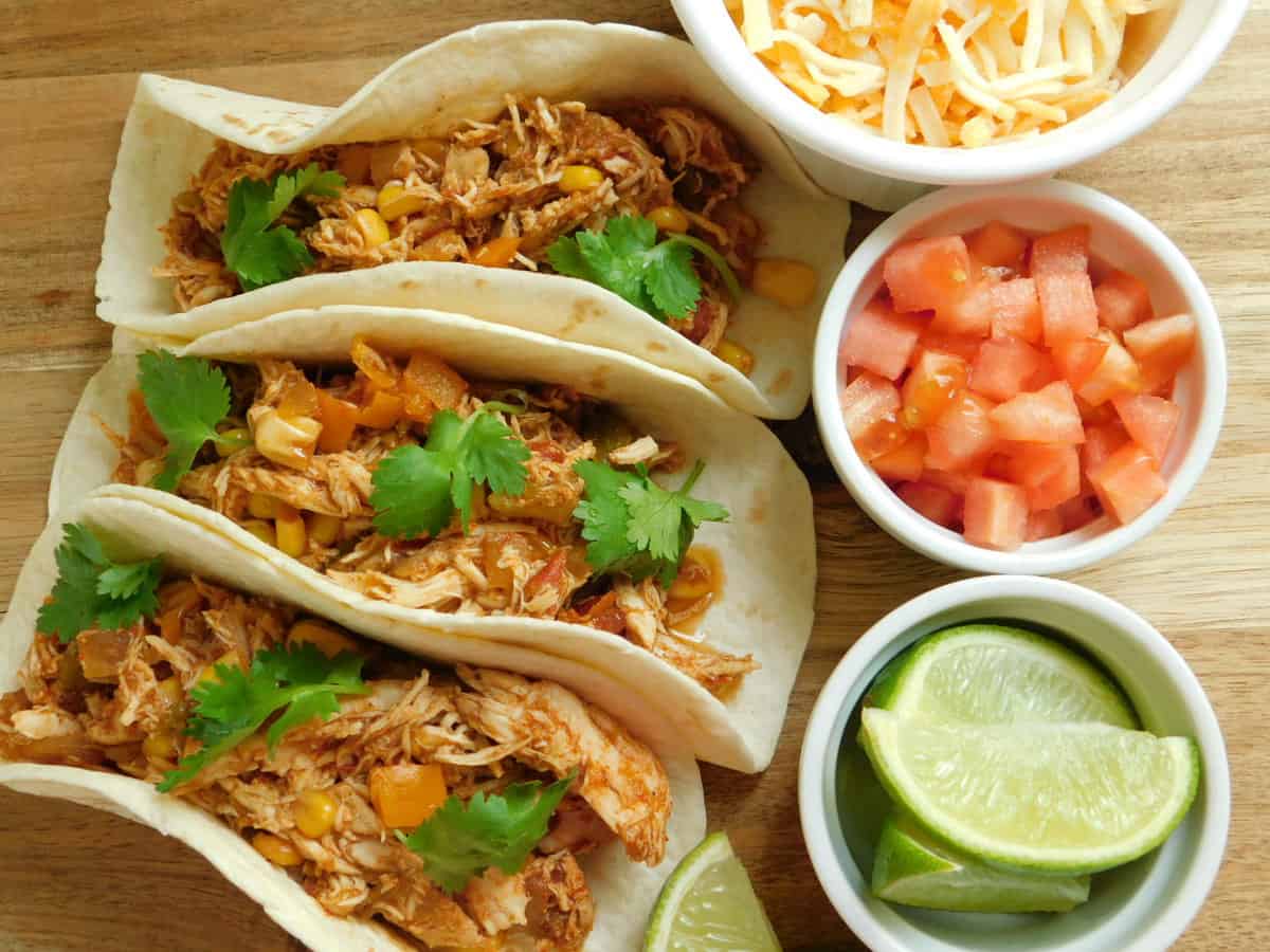 three southwest chicken tacos with toppings