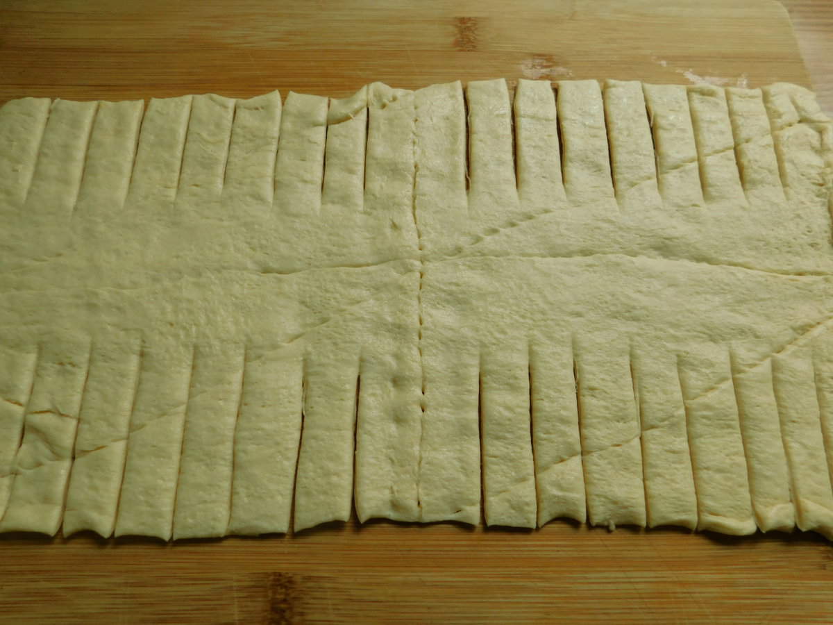pilsbury reduced fat crescent rolls stretched out on cutting board
