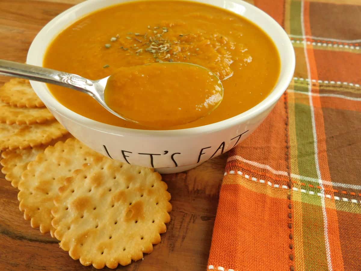 roasted pumpkin and carrot soup in white bowl