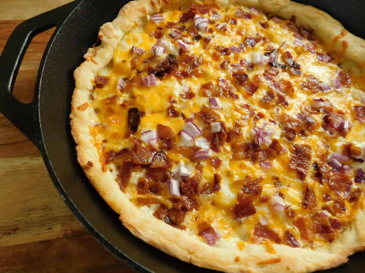 loaded potato pizza in cast iron skillet