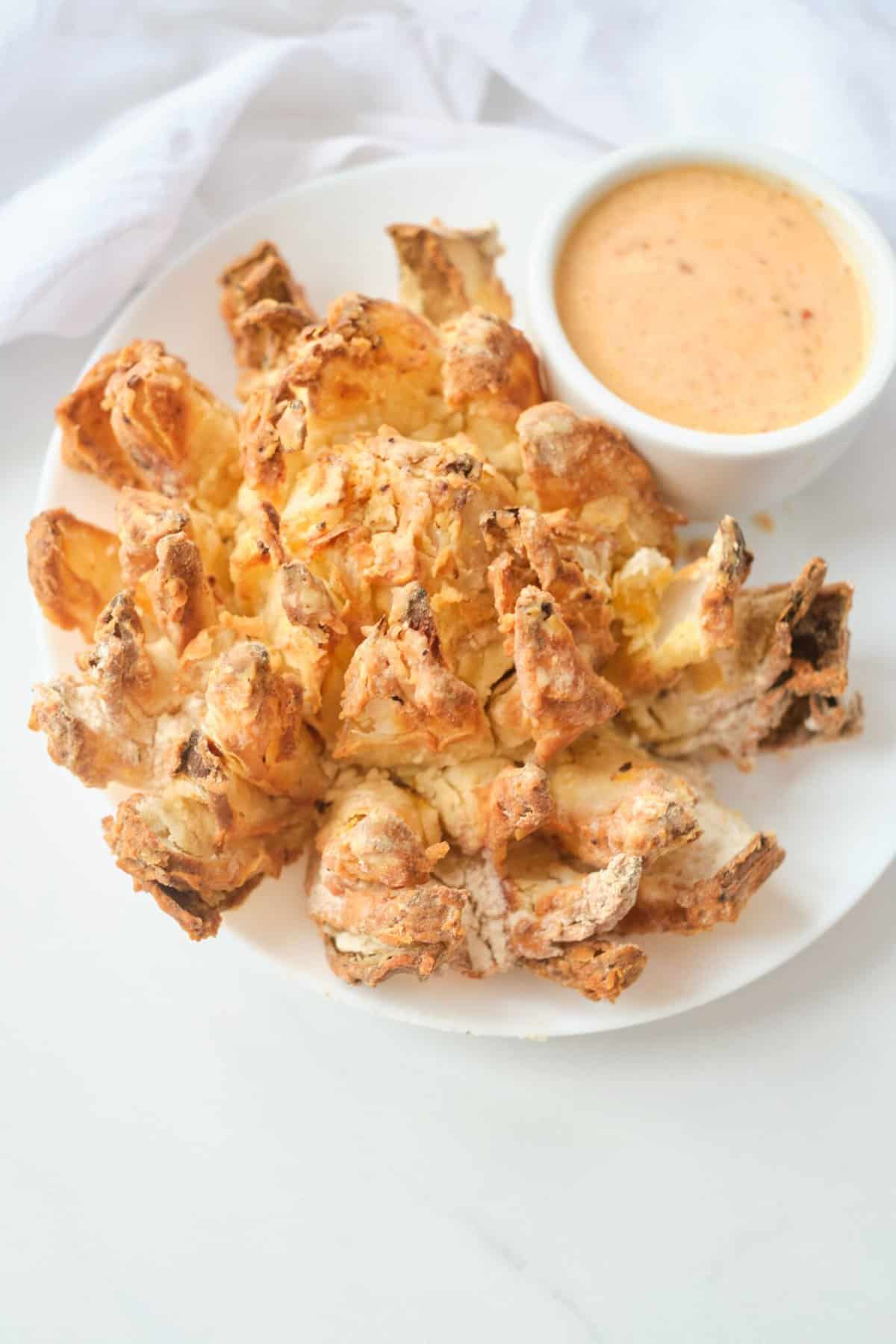 air fryer bloomin onion on white plate