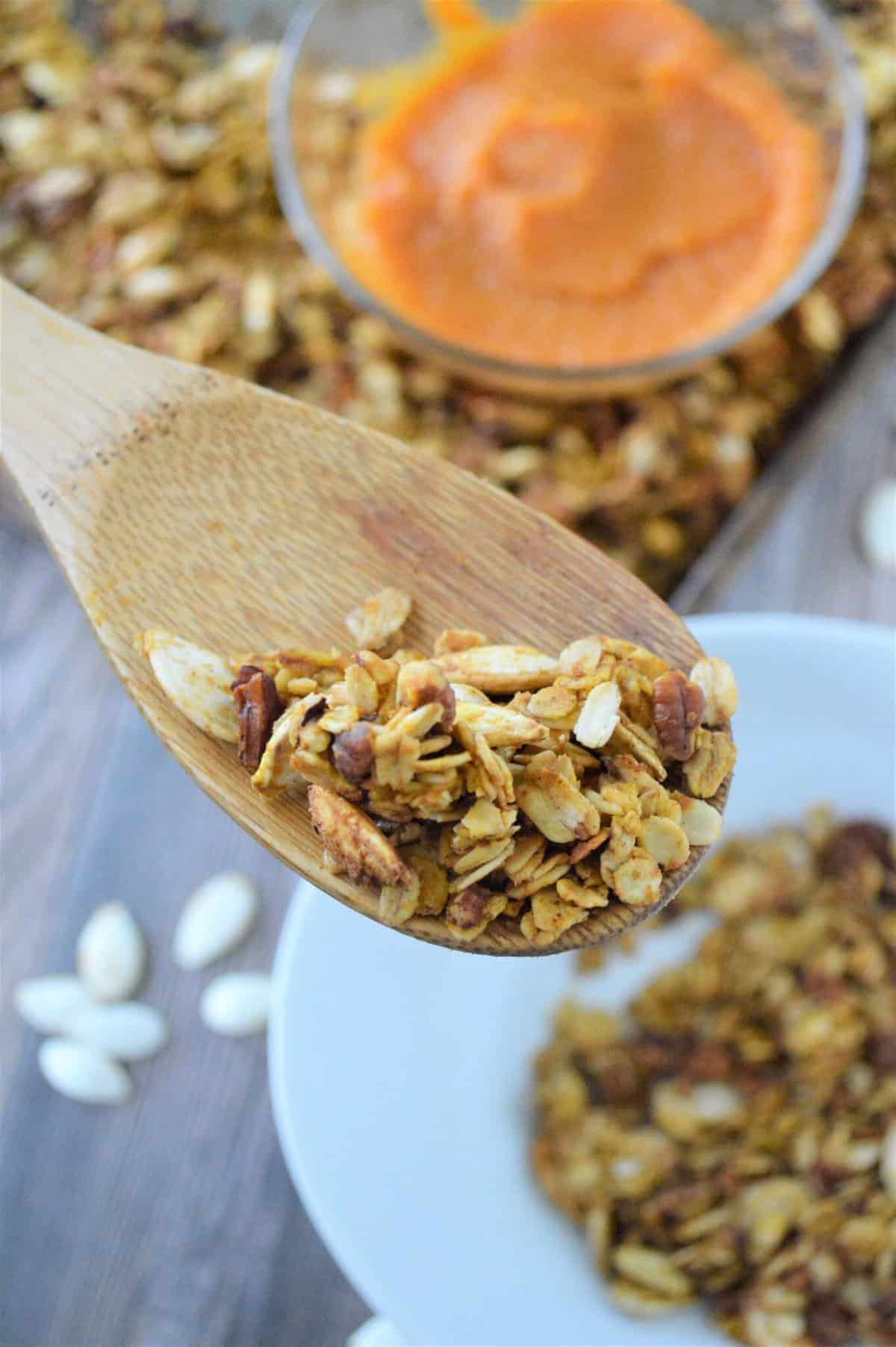 ww pumpkin granola recipe on wooden spoon