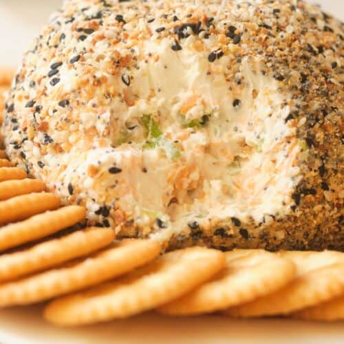 cream cheese ball with crackers on white plate