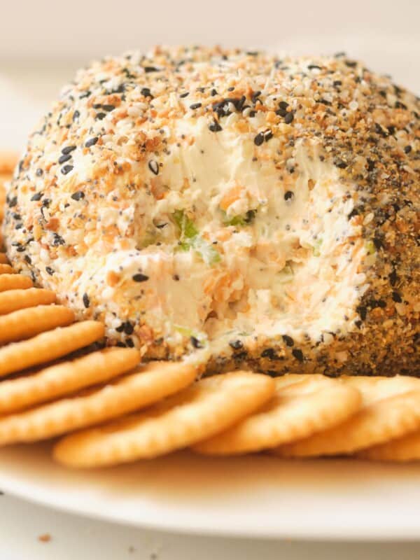cream cheese ball with crackers on white plate
