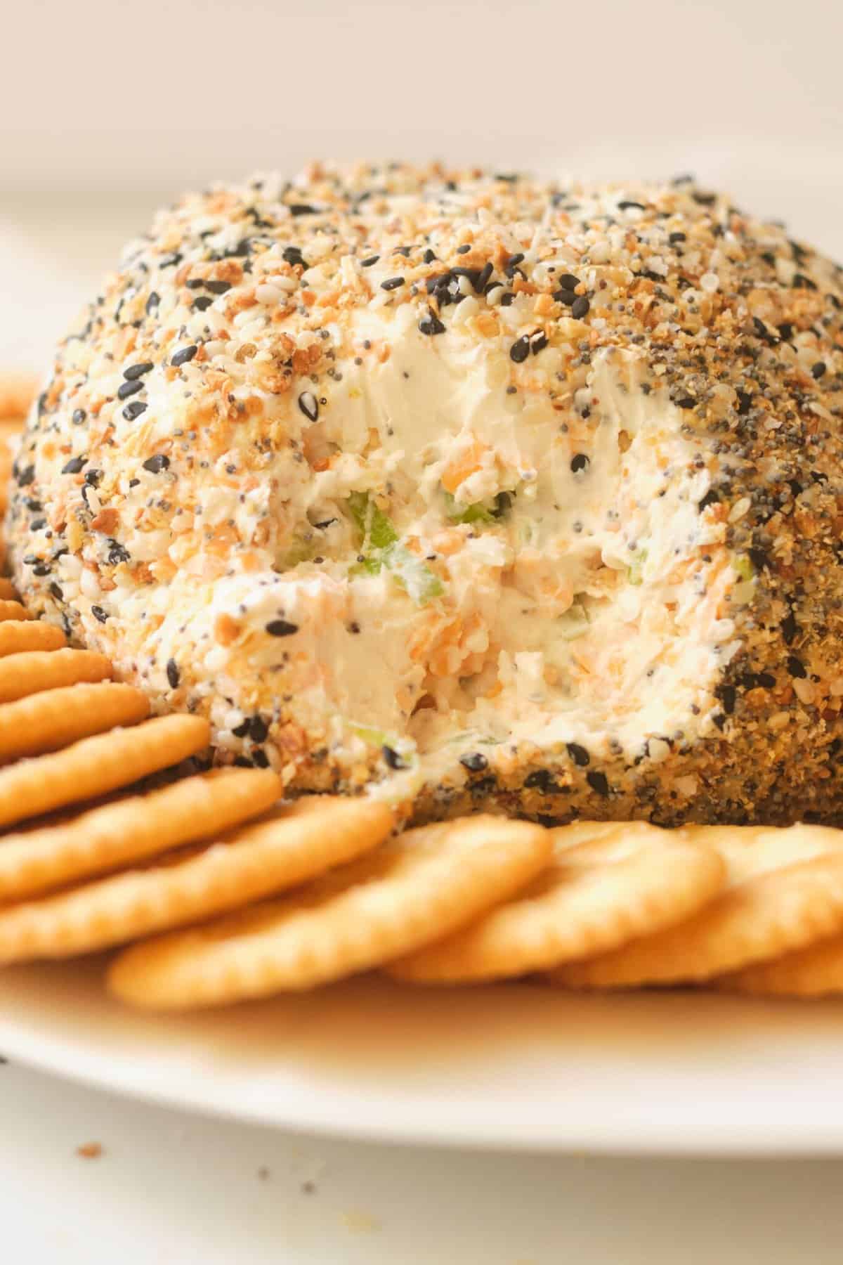 cream cheese ball with crackers on white plate