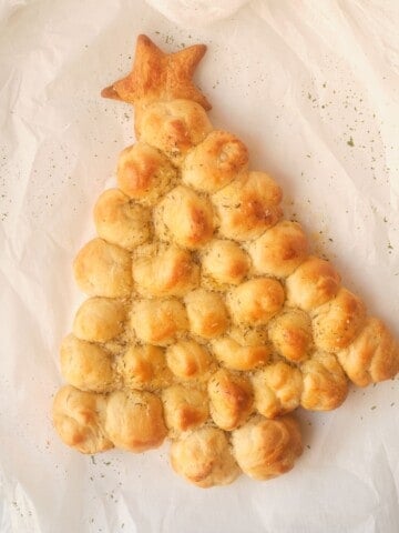 christmas tree pull apart bread on white parchment paper