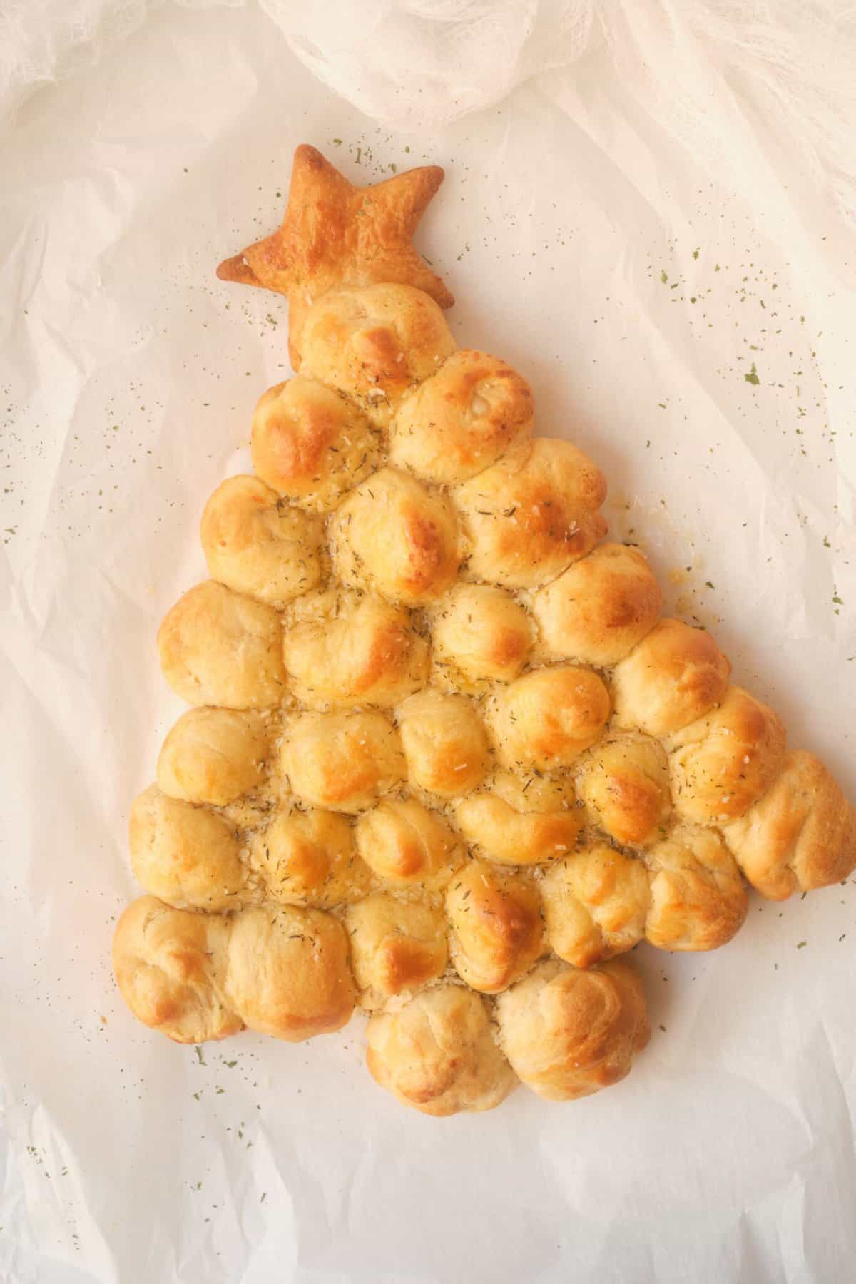 christmas tree pull apart bread on white parchment paper