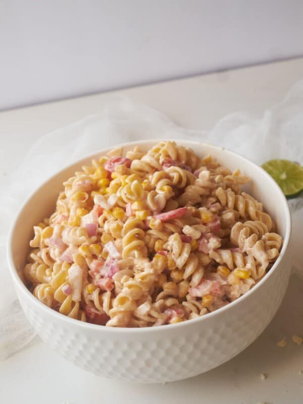 zesty corn pasta salad in white bowl