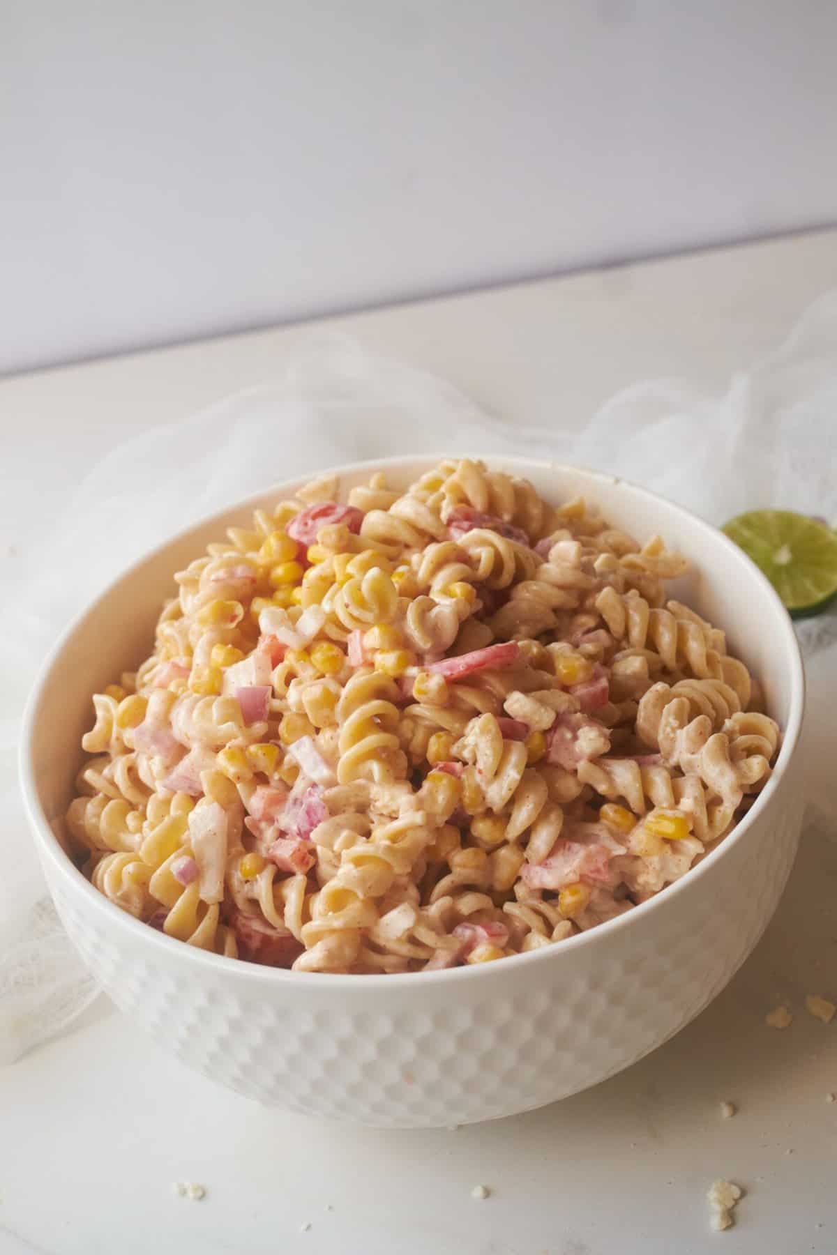 zesty corn pasta salad in white bowl