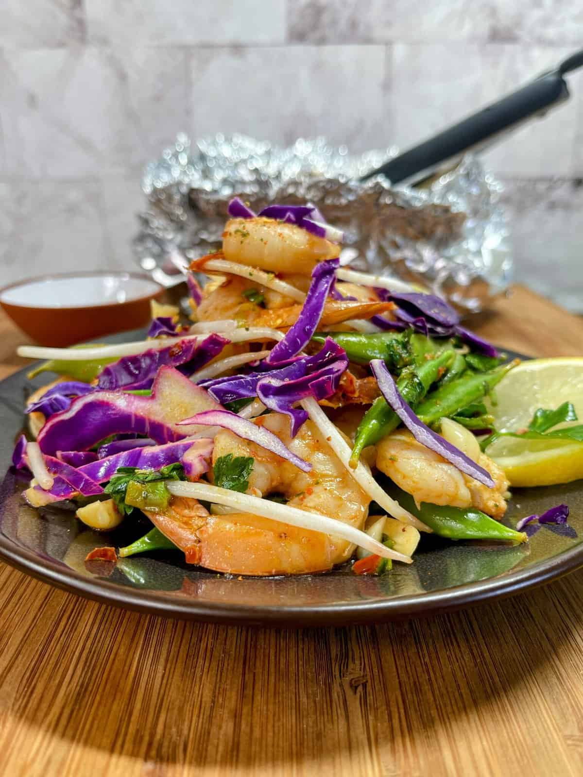 plate of snap pea and cabbage shrimp foil pack