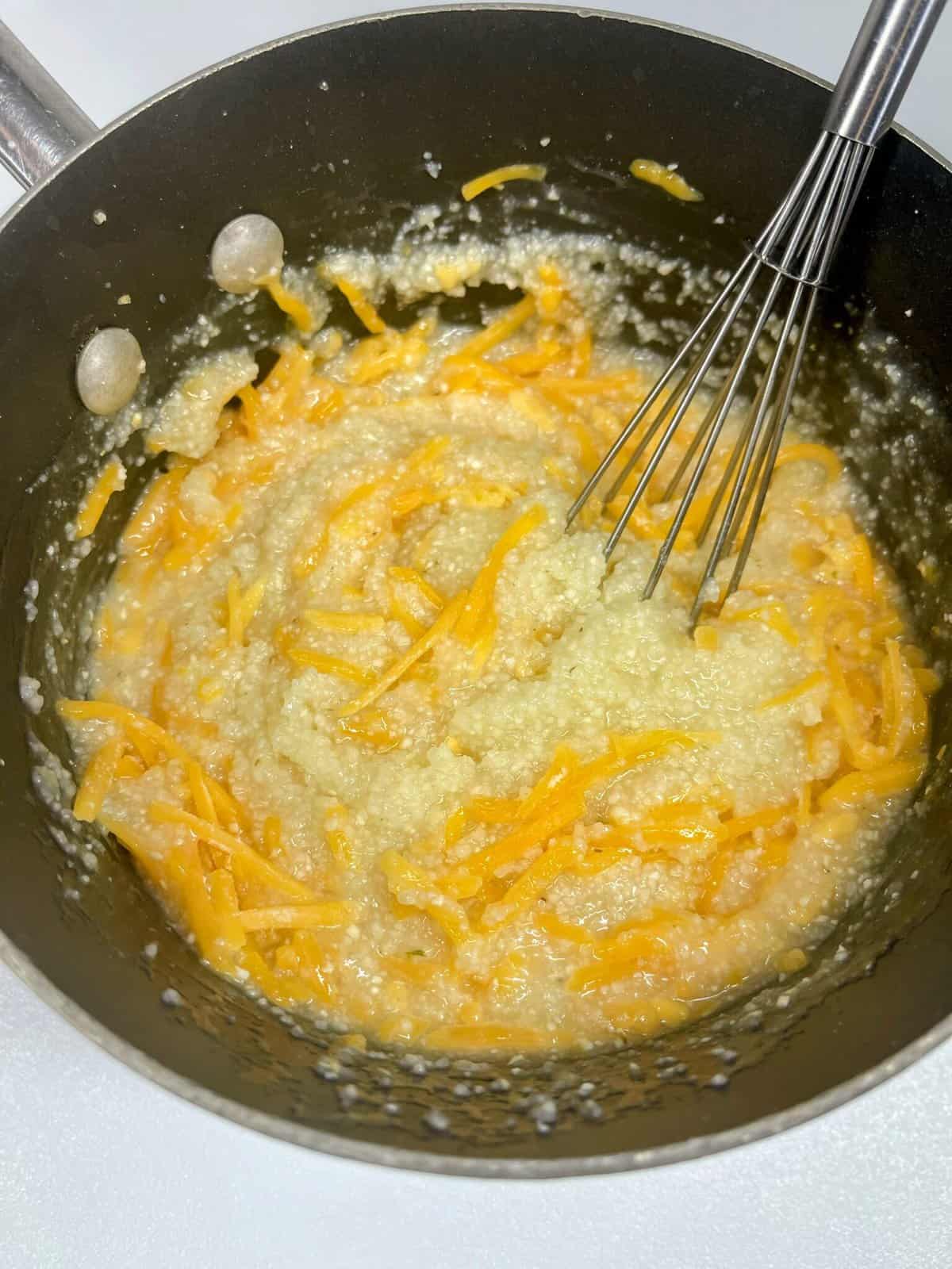 Cooked grits with cheese in a pot