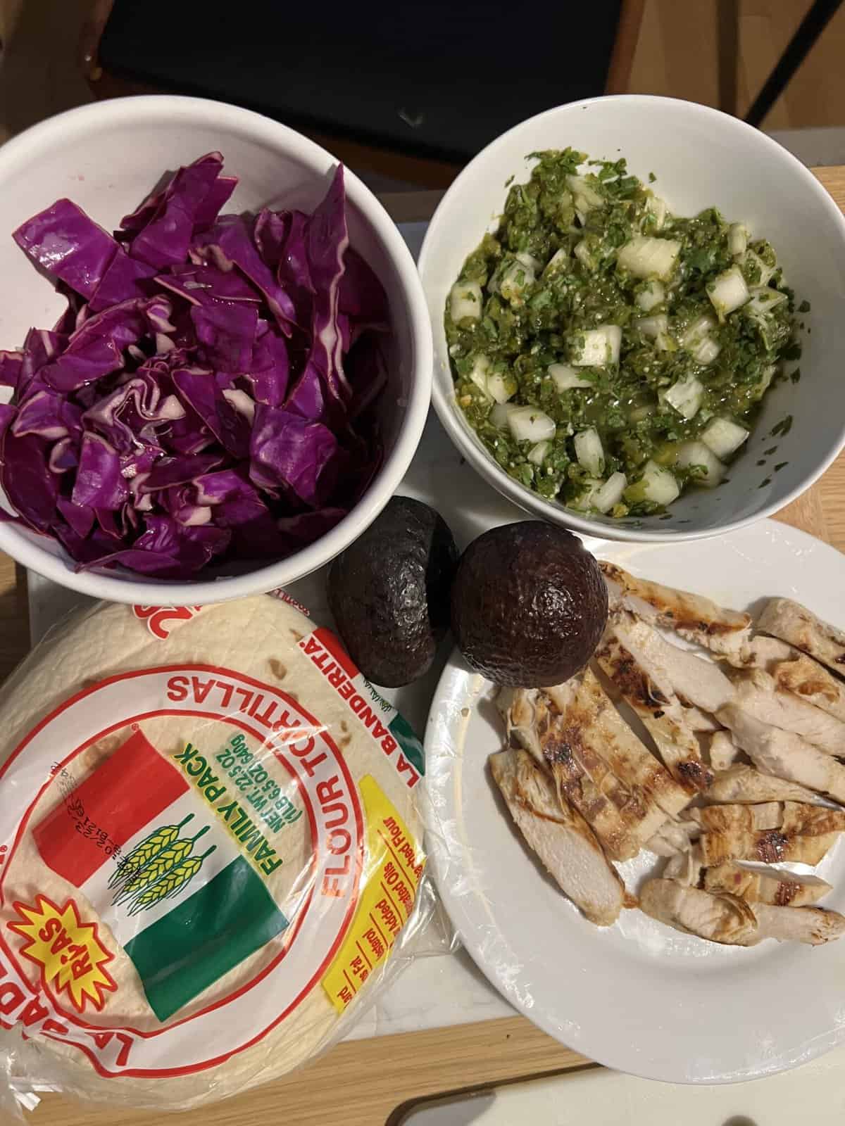 ingredients for weight watchers chicken tacos--cabbage, salsa verde, chicken, tortilla shells