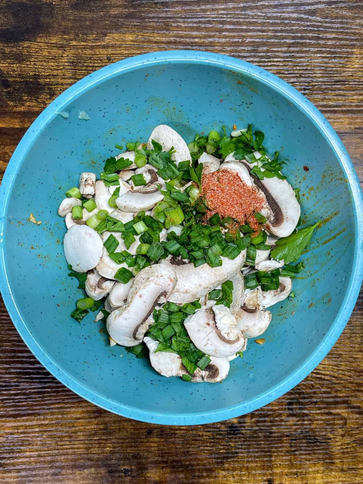 mushrooms, green onion, cilantro, and seasoning in a bowl