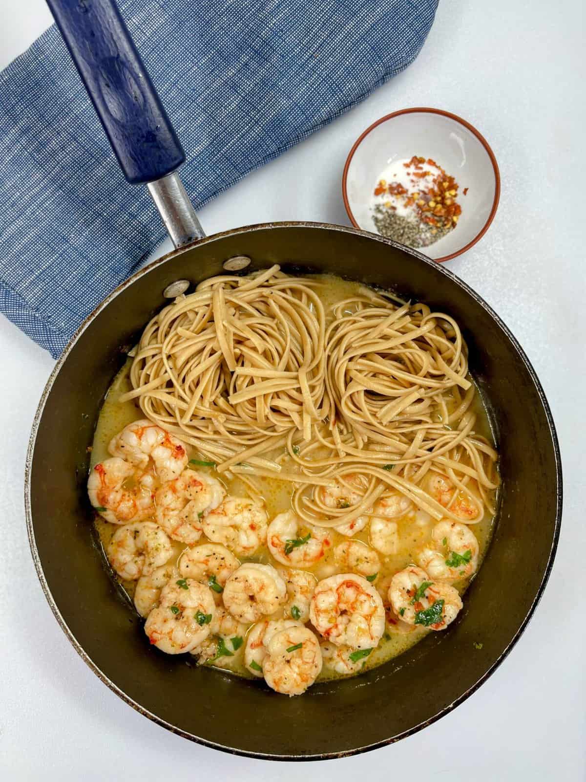 cooked shrimp scampi and noodles in cooking pan