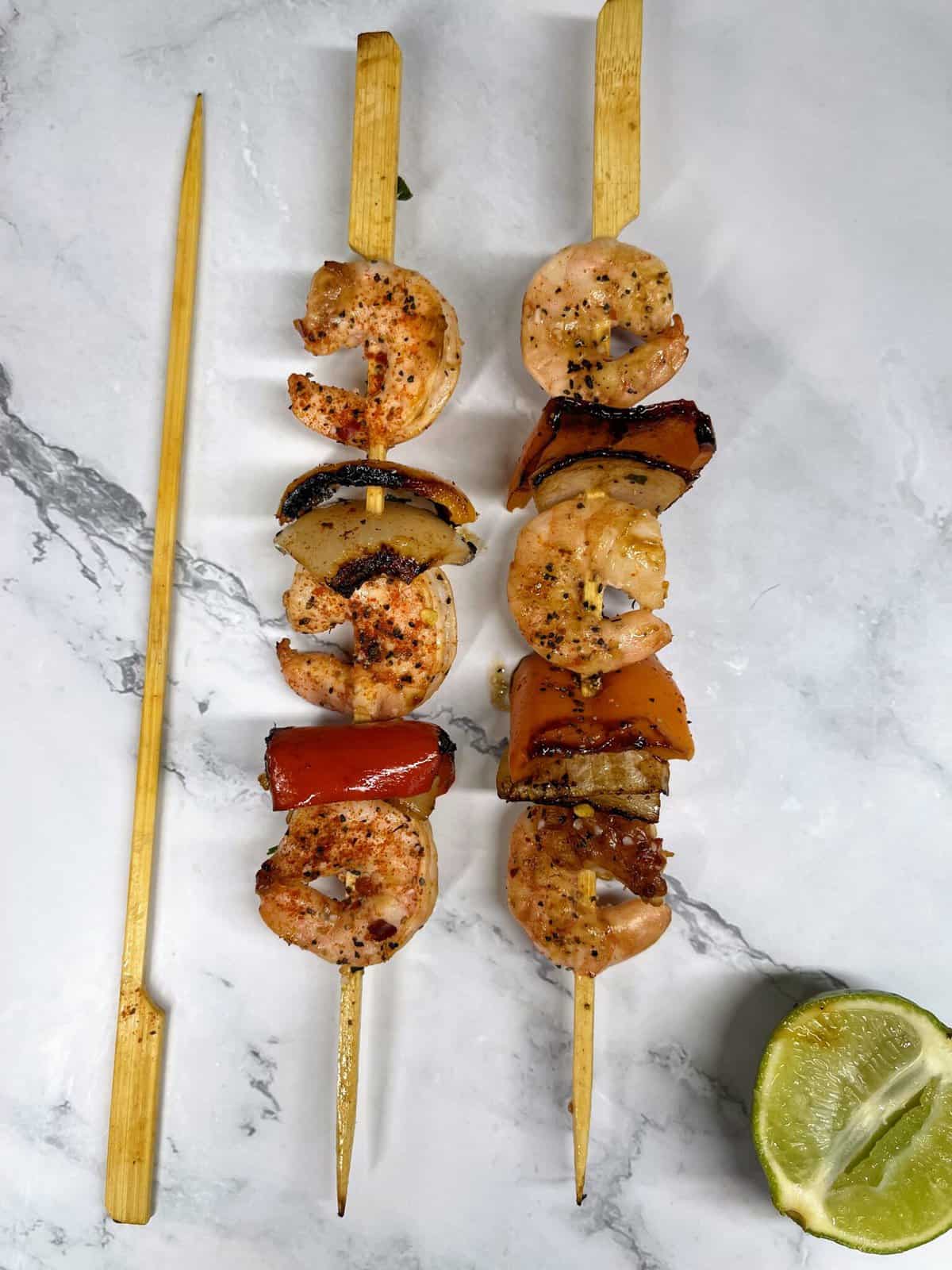 two cooked shrimp skewers