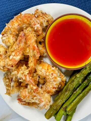 cooked coconut shrimp and asparagus