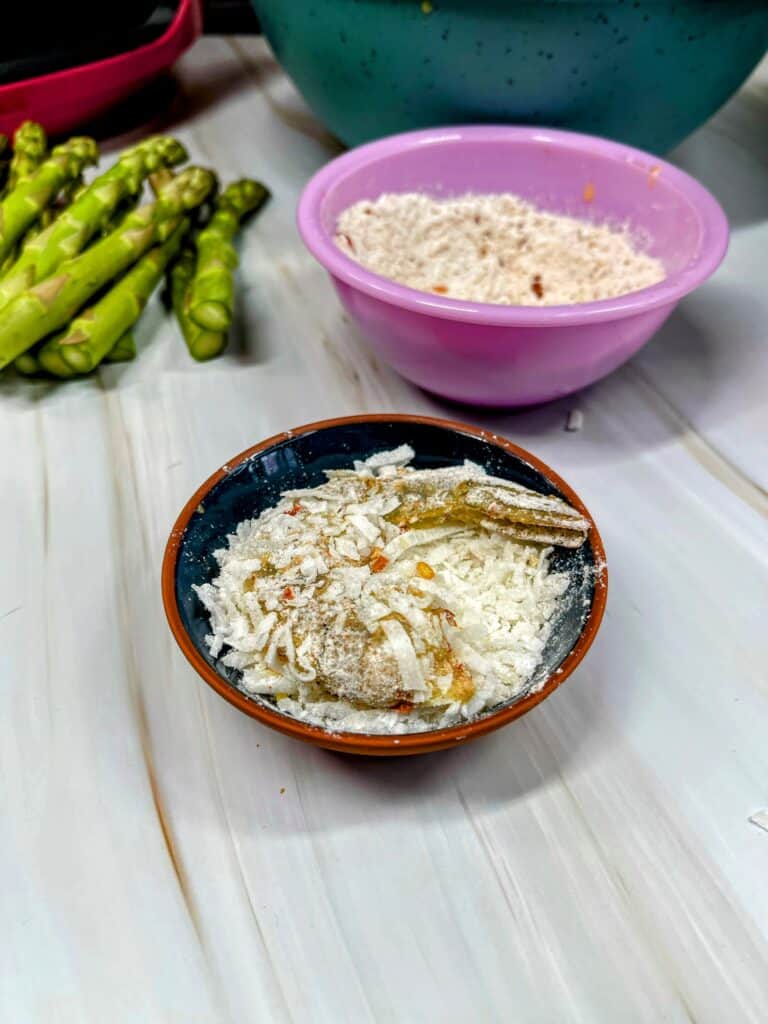 uncooked shrimp dipped in shredded coconut