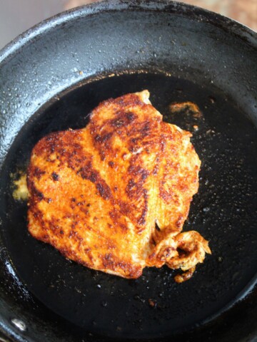Blackened chicken in saucepan