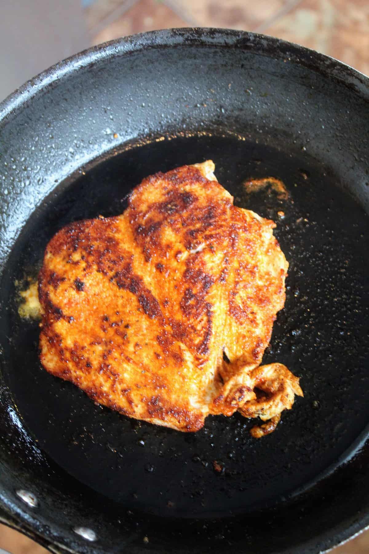 Blackened chicken in saucepan