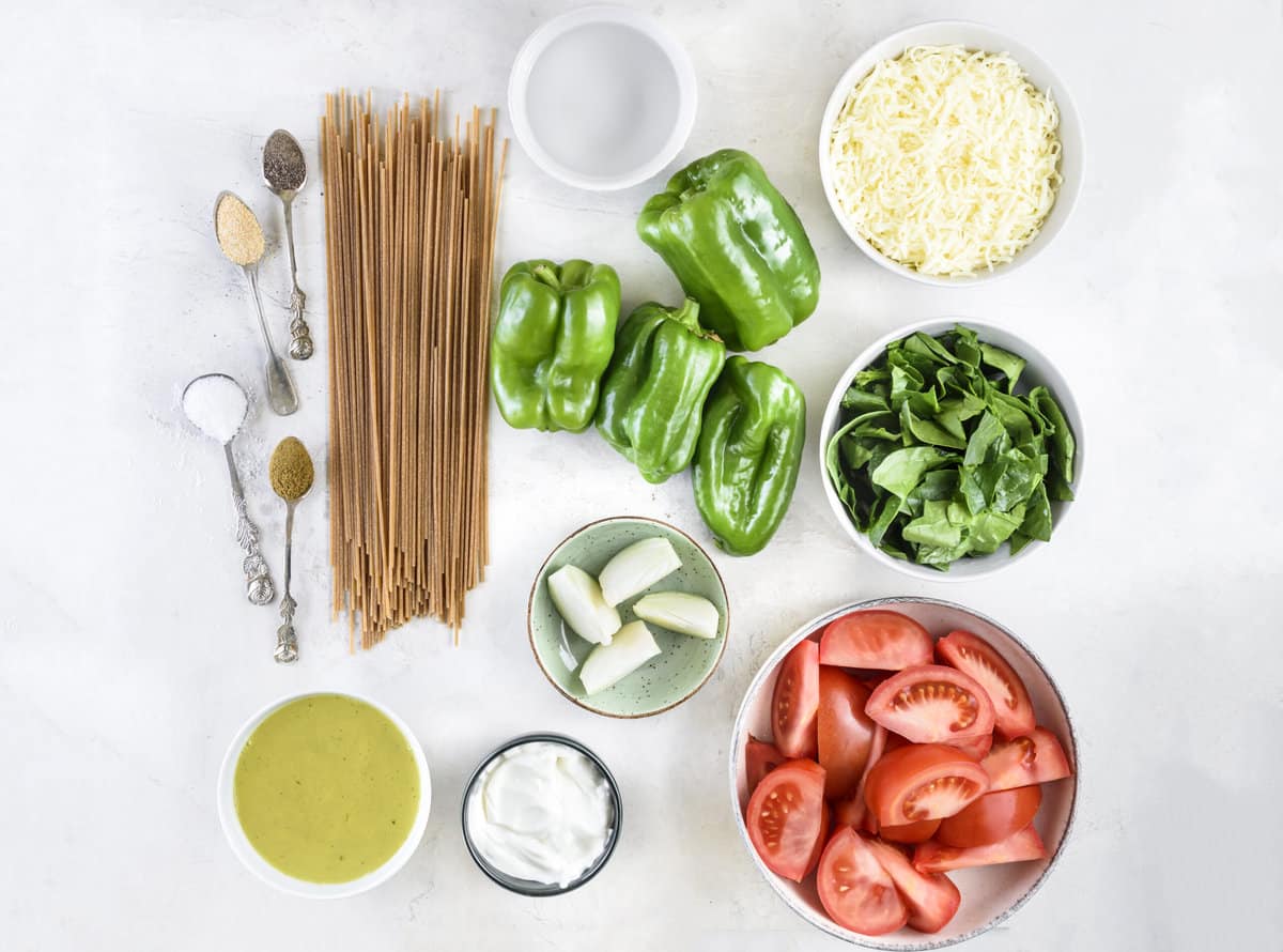Ingredients for healthy green spaghetti on white board