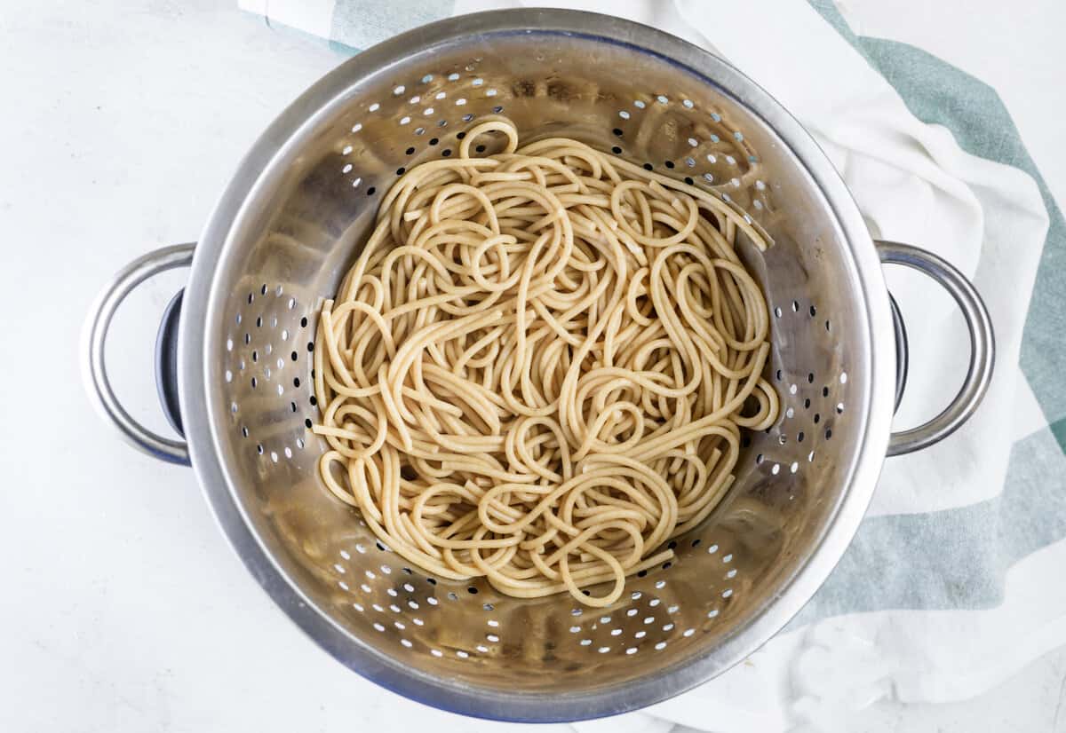 Whole wheat spaghetti in pasta strainer