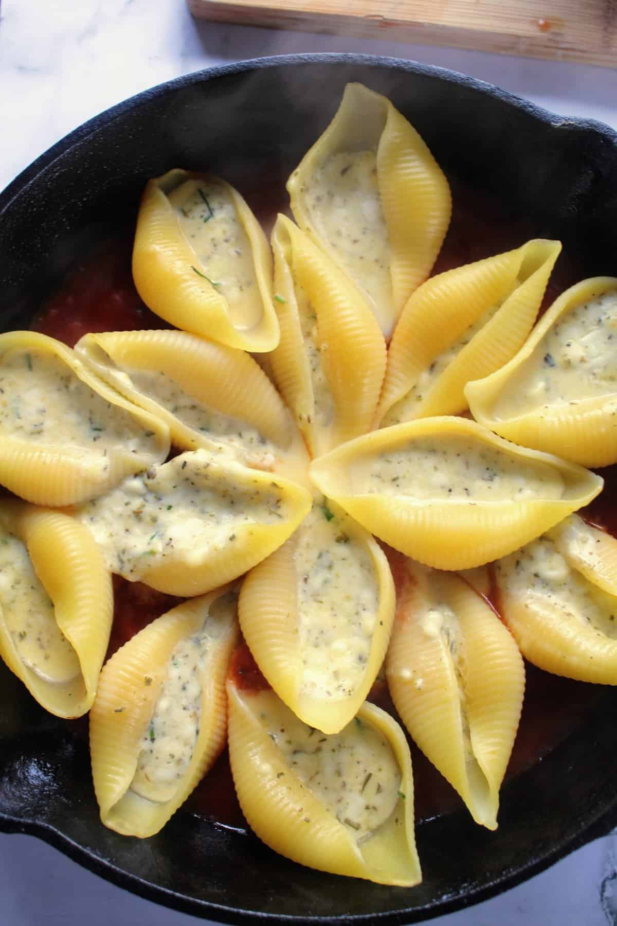 https://drizzlemeskinny.com/wp-content/uploads/2023/03/Stuffed-shells-with-the-cheese-mixture-arranged-over-the-marinara-scaled.jpg