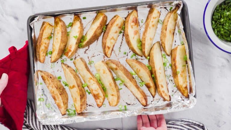 cooked potato wedges on a baking sheet