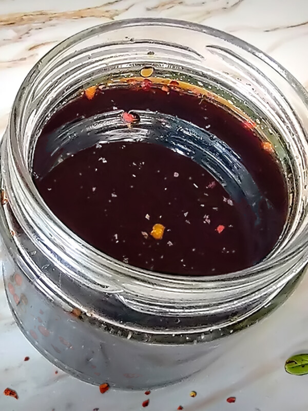 Vegan Worcestershire Sauce in jar on white counter