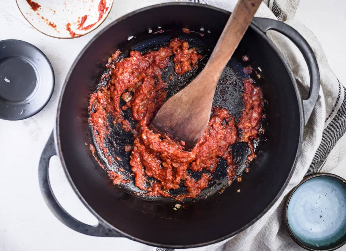 Garlic and Shallots sauteeing in pan with tomato paste