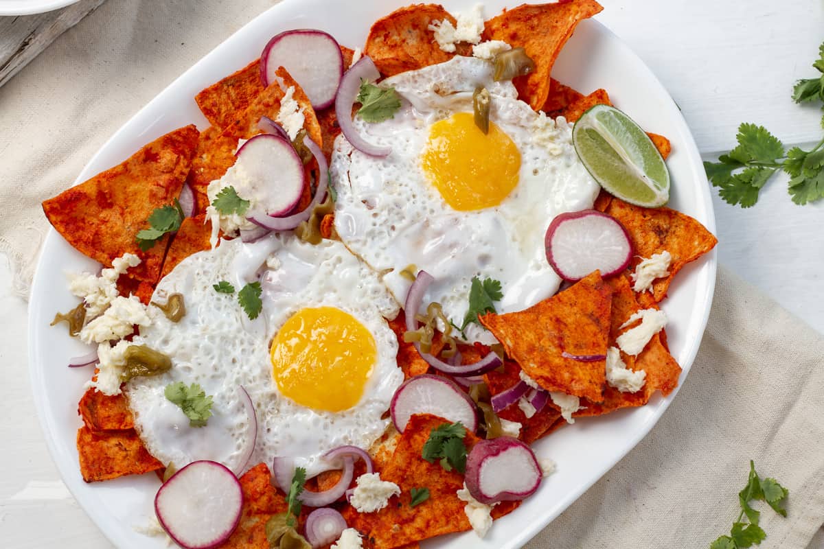 red chilaquiles on white plate