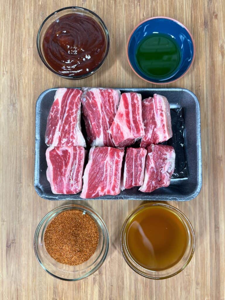 raw beef short ribs with sauce and seasoning