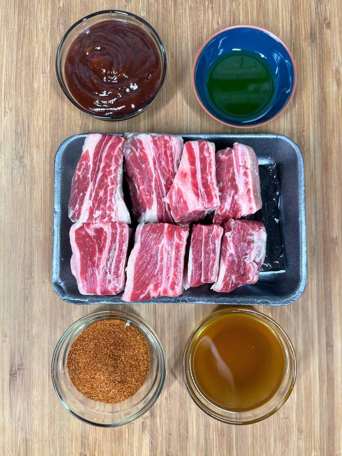 raw beef short ribs with sauce and seasoning