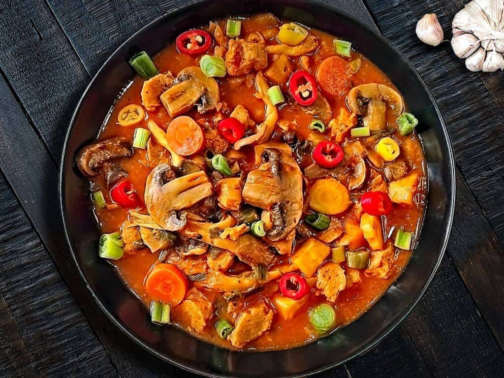 Mushroom stew in black bowl