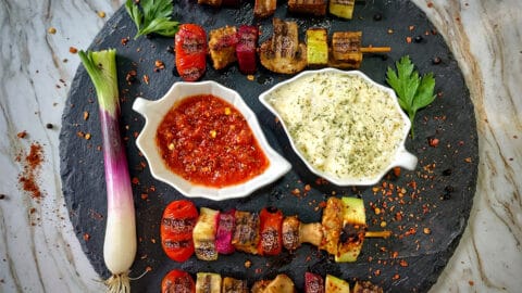 Vegan kebabs on black plate