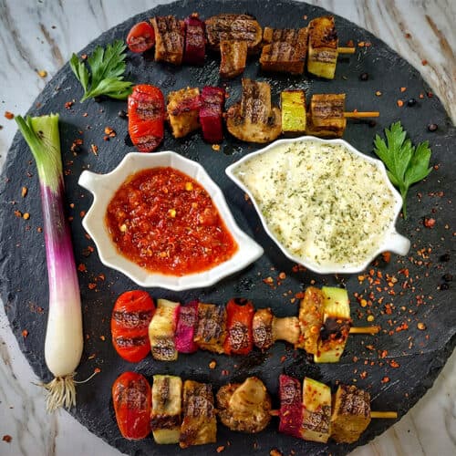 Vegan kebabs on black plate