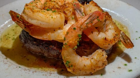 cooked steak topped with shrimp