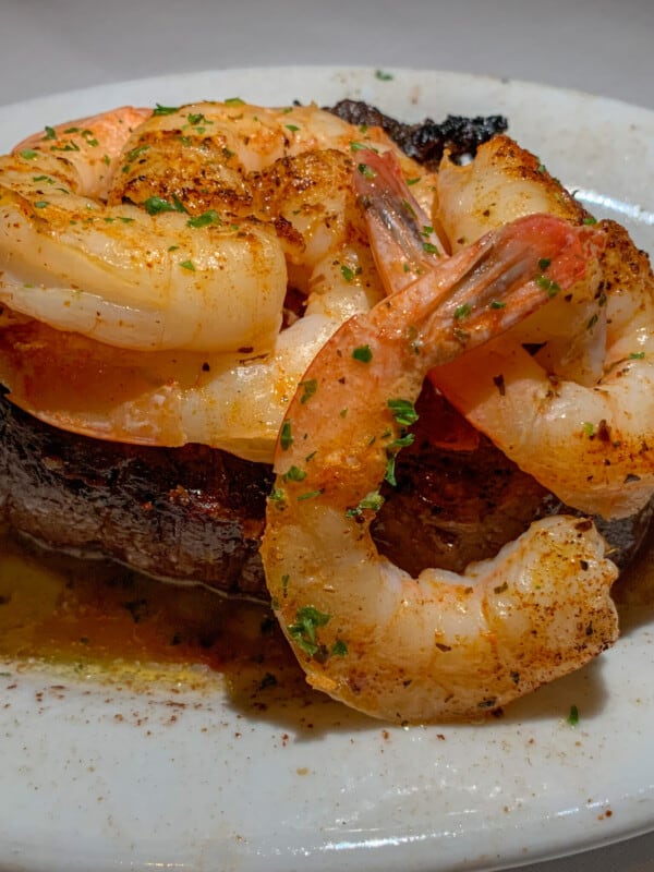 cooked steak topped with shrimp