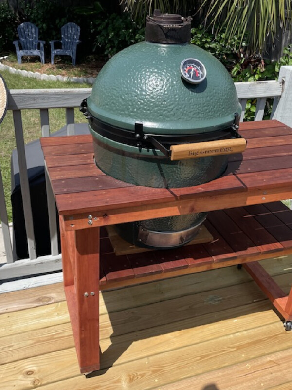 big green egg with table on deck