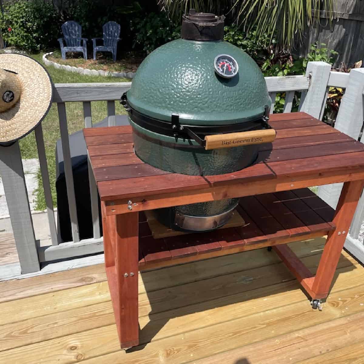 big green egg with table on deck