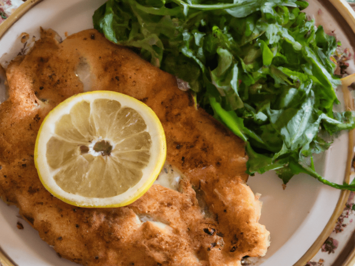 air fried chicken milanese on white plate