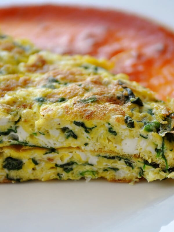 Omelette with spinach and tomatoes sauce.