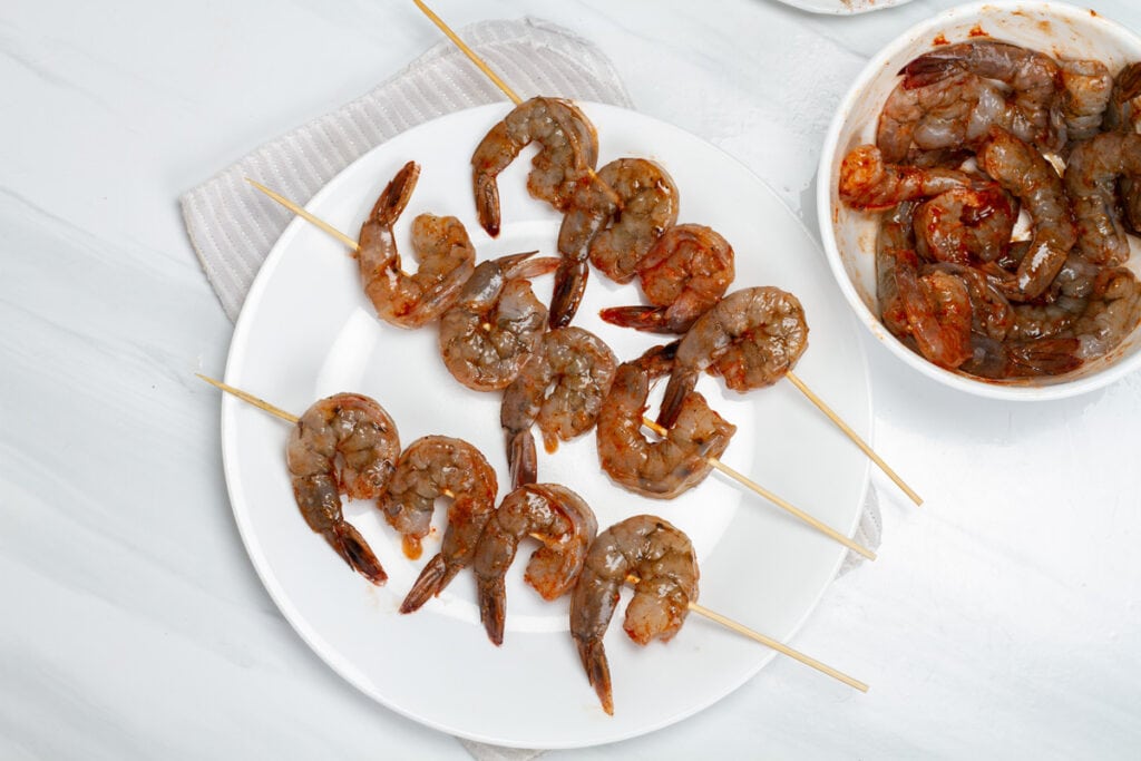 shrimp skewers on white plate 